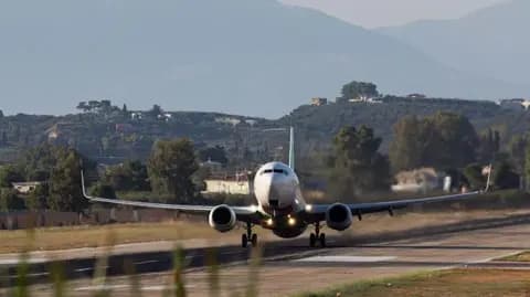 A plane taking off from Zakynthos International Airport, with Mount Skopos in the background