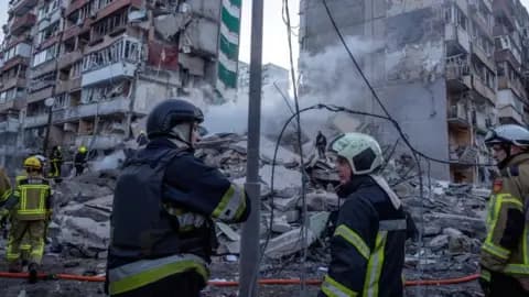 Emergency service workers search a smouldering building